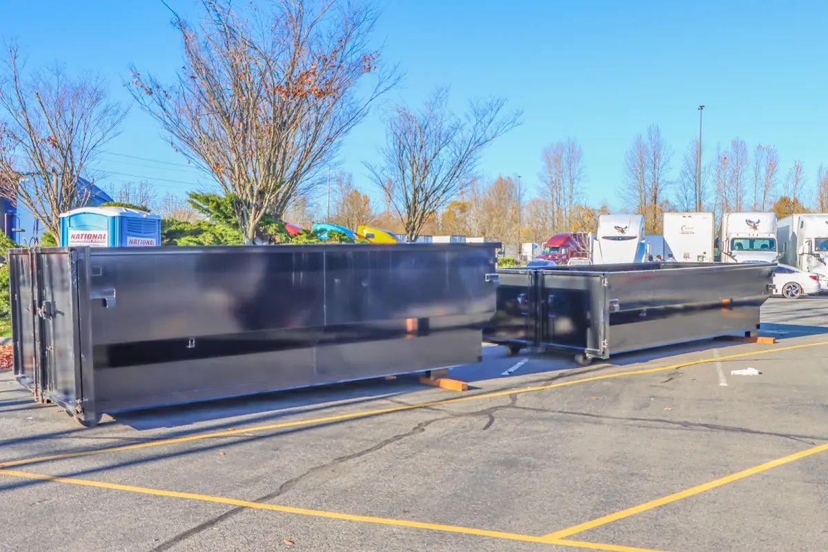Professional dumpster rental service with roll-off container on residential driveway in Archer Lodge
